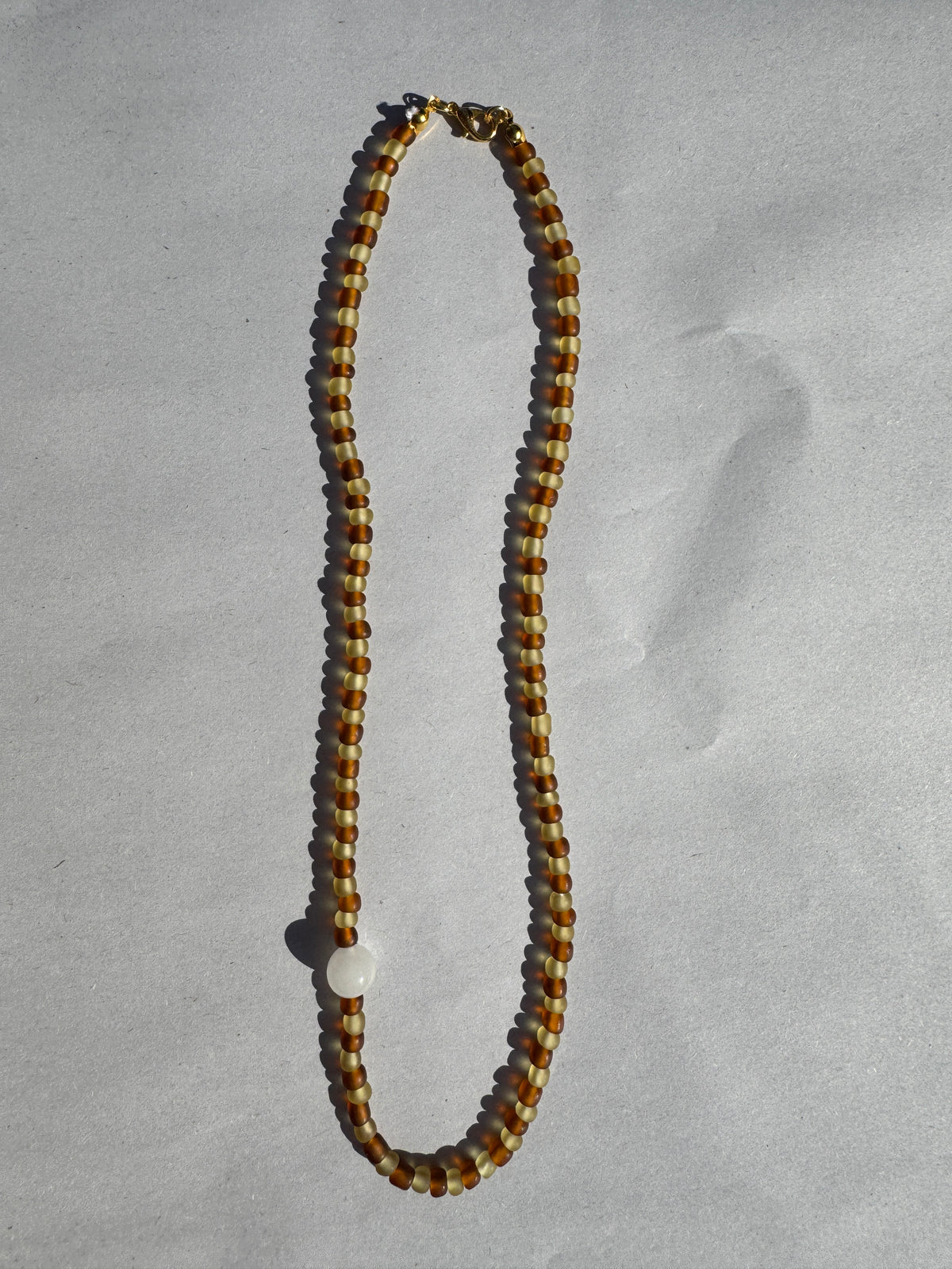 BEADING FOR PALESTINE STRIPE NECKLACE BROWN & YELLOW